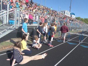 photo by Dennis Dalman Middle-school students wait for a kickball game to begin and to honor their principal, Julie Tripp, with a surprise honor rally.