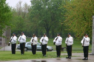 photo by Steven Wright Members of the local color guard deliver a 7-gun salute at the conclusion of Monday's ceremony. 