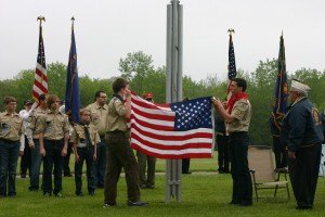 photo by Steven Wright Members of the local Boy Scouts, assisted by Jerry Hovanes, raise the flag before the ceremony on Monday.