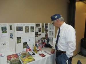 photo by Cori Hilsgen American Legion Post 328 Commander Chuck Kern views a display, put together by members of the American Legion Women's Auxiliary of St. Joseph, about the St. Joseph, St. John's and Yankee cemeteries. 