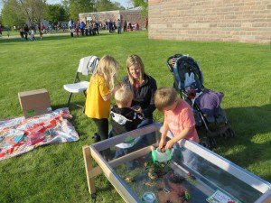 photo by Cori Hilsgen St. Cloud resident Judy Kelsch and her children (left to right) Mary, 6, Charlie, 2, and Henry, 4, visited the bug station at the annual Spring Fling. 