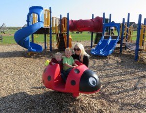 photo by Cori Hilsgen St. Cloud resident Tiffany Weller (back) played with her children Keelan, 1, (left) and Mason, 3, at the playground during the annual Spring Fling held at Colts Academy. 