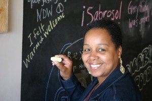 photo by Steven Wright Felicia Frelix of St. Paul writes a message on the chalkboard inside Smoke-In-D's BBQ. 