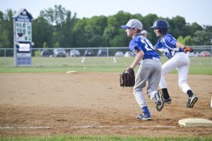 photo by Hannah Marie and Myles B. Photography Jackson Vos (#26, age 11, 1st base) of Sartell, attempts to get a the runner out in the Sartell vs Brainerd middle school game.
