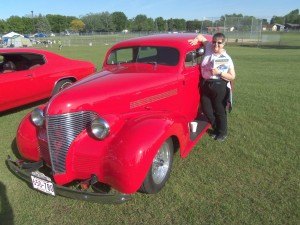 photo by Dennis Dalman Claudia Germann of St. Cloud leans against an antique car as she greets visitors to Relay for Life June 5 on the grounds of Sartell Middle School. Germann was trying to interest all comers to consider volunteering as drivers to take cancer patients to and from their treatments. Germann, a two-time cancer survivor, is coordinator of the Road to Recovery volunteer drivers’ program. 