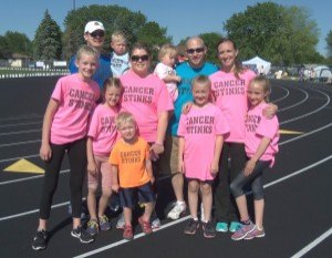 photo by Dennis Dalman A team dubbed “Team Jerry” prepares to walk to raise money for the American Cancer Society during the all-night Relay for Life rally at Sartell Middle School June 5. The team was named in honor of Jerry Larson of St. Cloud, who passed away in June 2014 of cancer. He was the long-time owner of the Ace Bar and Grill in downtown St. Cloud. From left to right (first row) are Abby Daniels, Hailey Daniels, mother Jessica Daniels with son Nolan Daniels, Candice McLeod and Kaylee Hilldebrand. In the second row are Adam Daniels with toddler Sullivan Daniels, Daniel McLeod with toddler Avery McLeod and Michelle McLeod, who works at the CentraCare Coborn Cancer Center. 