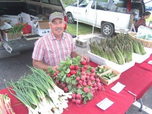 photo by Dennis Dalman Chuck Long of Milaca is one of many vendors at the Sartell Farmers’ Market, which debuted at its new Thursday venue June 11 – the CentraCare Health Plaza in St. Cloud, just across the road from south Sartell. The market (also known as Market Monday) will still set up shop outside Sartell City Hall every summer Monday. Long, whose business is dubbed Greenbush Farms, has been selling at six farmers’ markets for eight years. “I love it,” he said. “I love interacting with the people who come to the markets.”