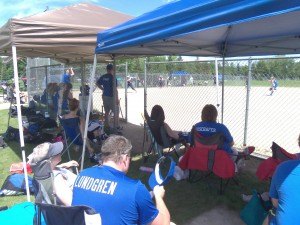 photo by Dennis Dalman Spectators watch a game of girls fastpitch softball during a June 20-21 tournament at Whitney Park in St. Cloud. Playing this game was the Sartell Swarm 16-U and a team from Hudson, Wis. 