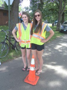 Brea Timlin (left) and Brittany Bodell worked as traffic directors at River Days Food Fest June 27 in Sauk Rapids. As members of the Sauk Rapids Dance Team, they worked to raise money for their team. 