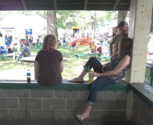 photo by Dennis Dalman Three friends share a lazy-day chat in the shade at River Days Food Fest.