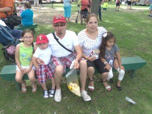 photo by Dennis Dalman A family from St. Cloud takes a bench break at River Days Food Fest June 27 in Sauk Rapids. From left to right are Frida, Hugo Jr., Hugo, Claudia and Camila.