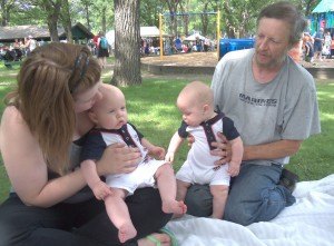 Photo by Dennis Dalman Five-month-old Marty (left) and his twin, Miles, enjoy the cool breeze at River Days Food Fest in Sauk Rapids June 27. At left is their mother, Kaylee Stang and at right is her father, the boys'  grandfather, Doug Stang. The Stang family lives in Sartell.