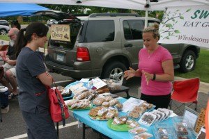 photo by Steven Wright Jessi Brinkman of Sauk Rapids showcases her gluten-free baked goods to Jenna Dunagan. Brinkman was one of 12 vendors at CentraCare's Farmer's Market on Thursday June 11.