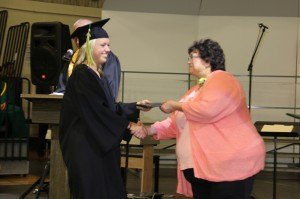 photo by Andrea Skillingstad Katie Cruikshank receives her diploma from Jan Solarz, a school board member. 