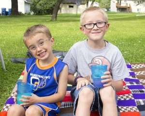 photo by Angie Heckman Alex (10) and Evan (4) Ostendorf, Sauk Rapids, enjoy a glass of lemonade while they wait for the parade to start on June 26.