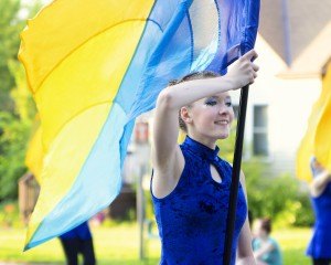 photo by Angie Heckman Izzy Kucala, a Sartell High School freshman this fall, marches with the color guard June 26 during the Sauk Rapids River Days parade. There are 67 students in the SHS marching band this year, which is in its second year after many years without a marching band.